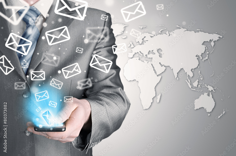 Business man holding smart phone and sending emails Business man holding smart phone and sending emails