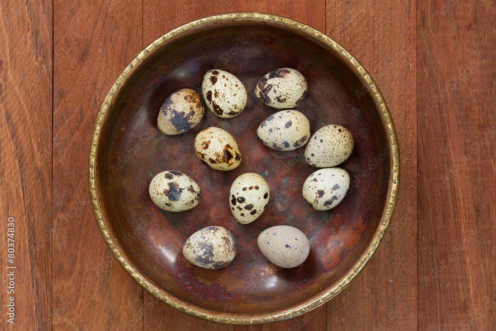 quail eggs on dish on brown background quail eggs on dish on brown background