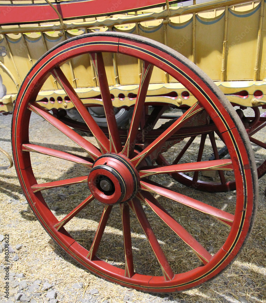 A Traditional Red Wooden Wheel on an Old Horse Cart.