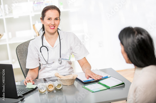 Obraz na plátně Homeopathy.Young woman in an office at the doctor homeopaths.
