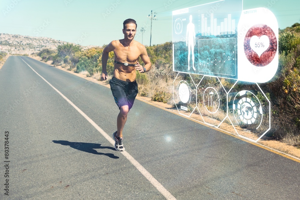 Athletic man jogging on open road with monitor around chest - obrazy, fototapety, plakaty 