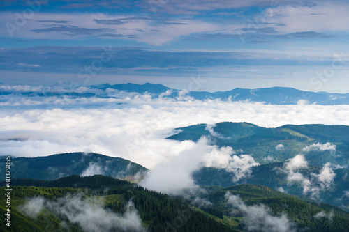 Clouds in the morning rise over the mountains in the Carpathians