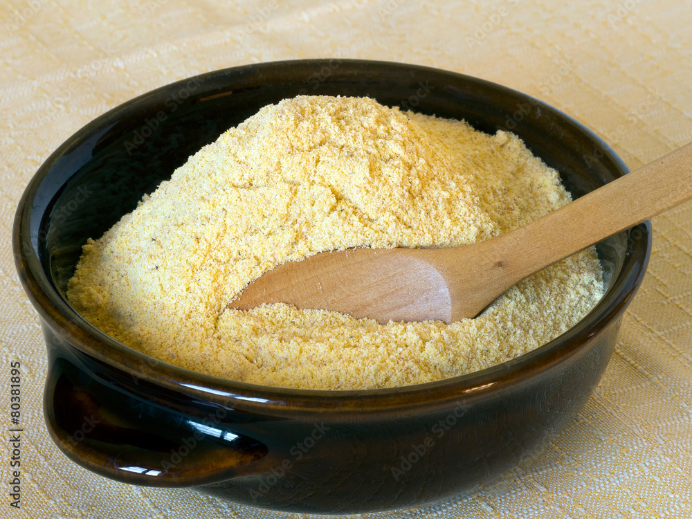 Maize flour, yellow, in bowl. Rustic stone ground. Maize flour, yellow, in bowl. Rustic stone ground.