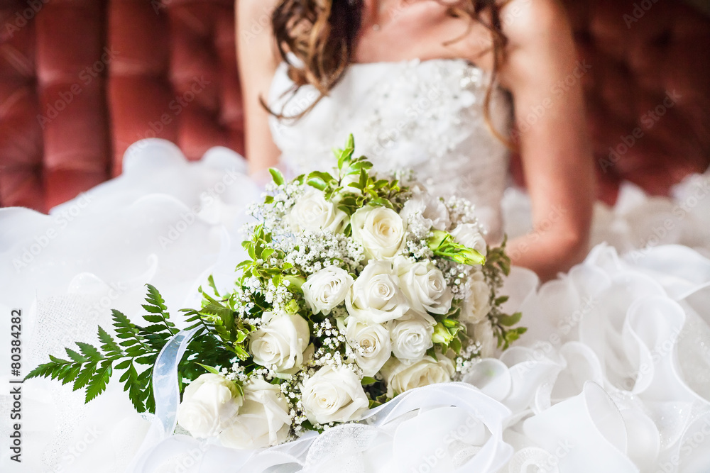 closeup bride holding bouquet of roses