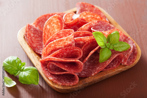 salami slices in wooden plate
