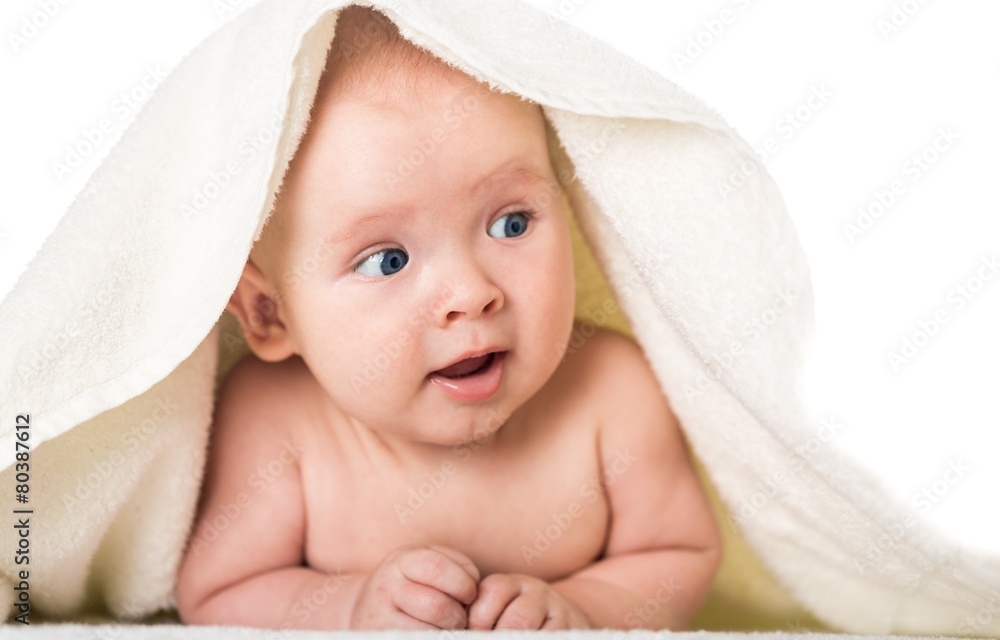 Smiling. Smiling baby looking at camera under a white blanket Smiling. Smiling baby looking at camera under a white blanket
