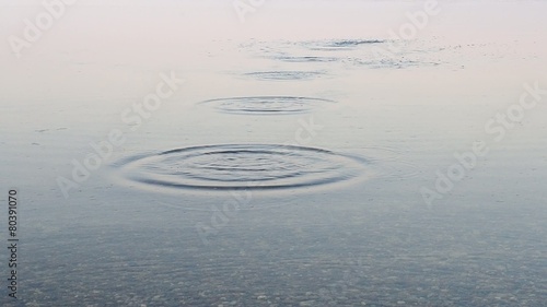 Close-up of stone skipping on water surface