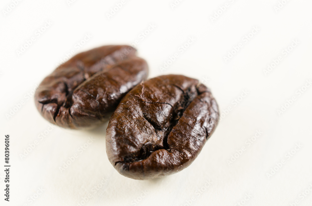 close up of roasted coffee beans isolated on white background close up of roasted coffee beans isolated on white background