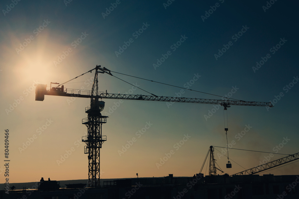 Tower crane silhouette at construction area Tower crane silhouette at construction area