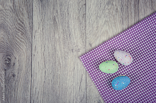 Artificial easter eggs on wooden background in rustic style