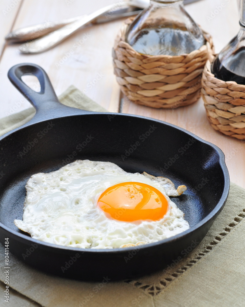 Breakfast the fried egg in a iron frying pan Breakfast the fried egg in a iron frying pan