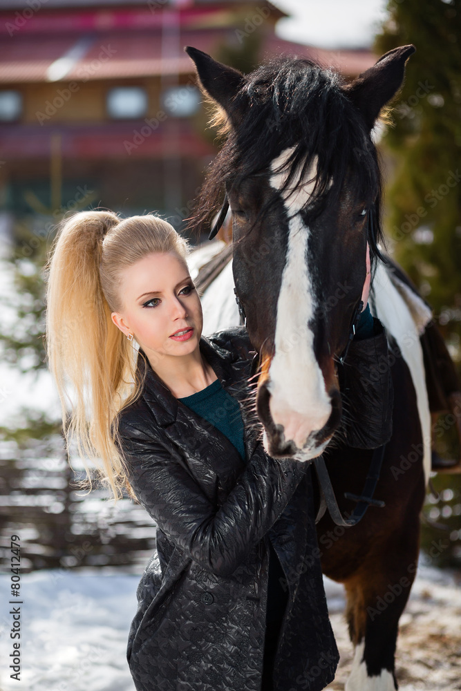 Obraz premium Young young girl goes on a brown horse