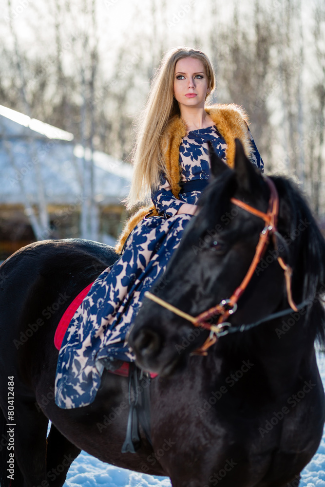Obraz premium Young young girl goes on a brown horse