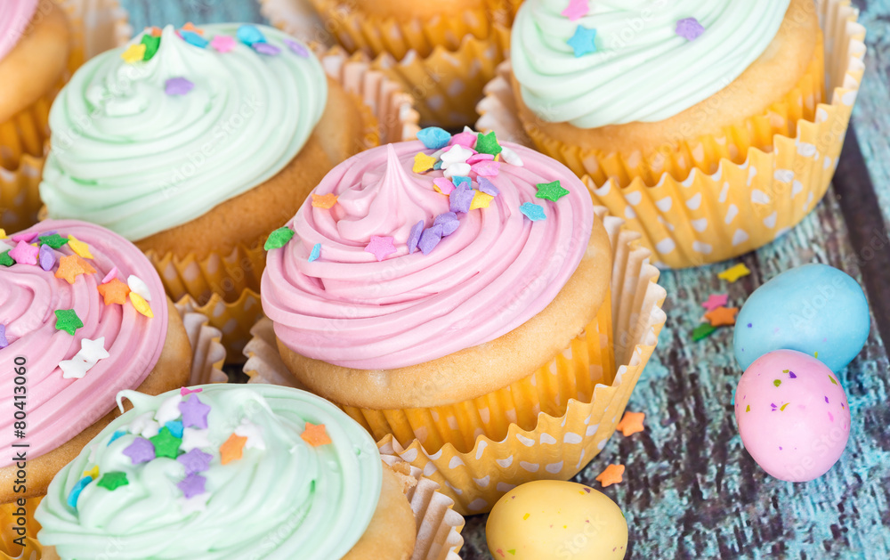 Pastel Easter cupcakes with candy and sprinkles Pastel Easter cupcakes with candy and sprinkles
