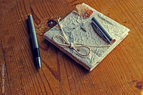 Old diary memories with pen on a wooden table