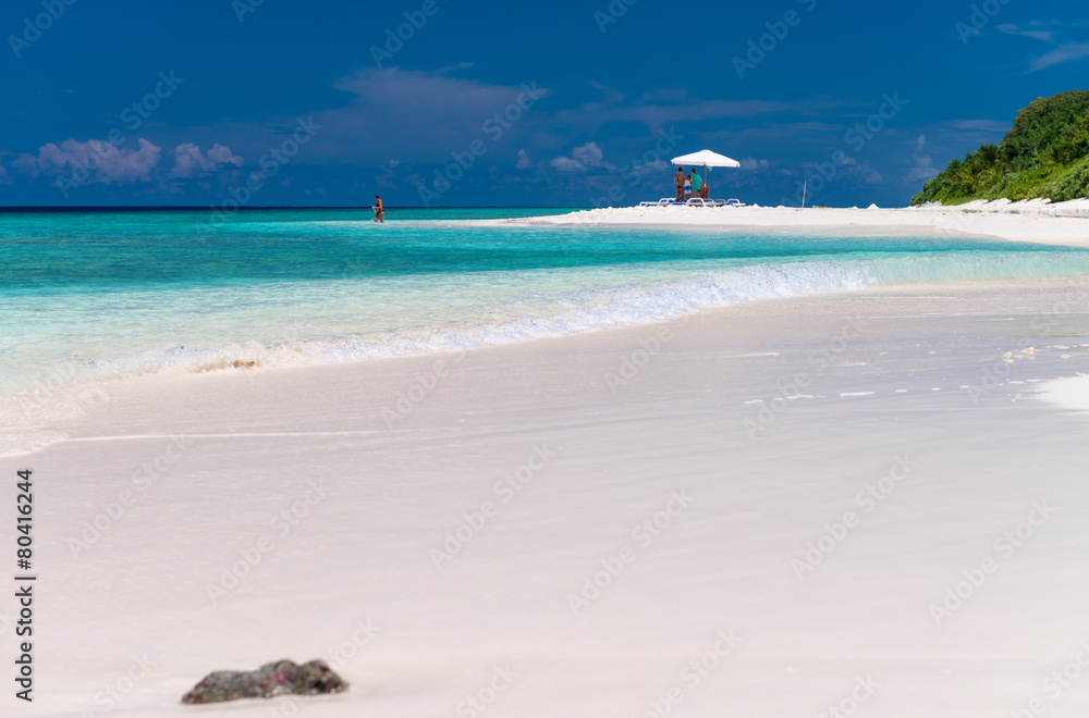 Beach umbrella on a white sand