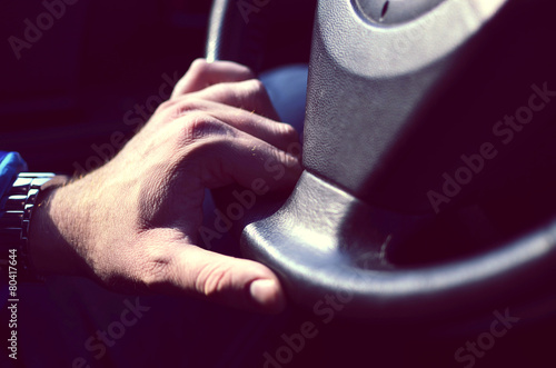 Driver hands holding steering wheel