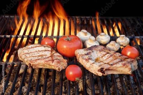 Two Tasty Rib Steaks, Tomato, Mushrooms Cooked Over  BBQ Grill. photo