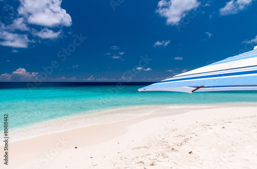Beach umbrella on a white sand