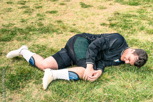 Photography Soccer player goalkeeper injured during amateur football match