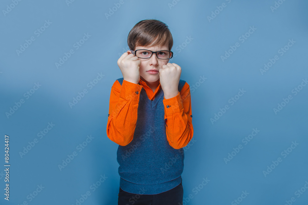 European-looking boy of ten  years in glasses frowning, unhappy