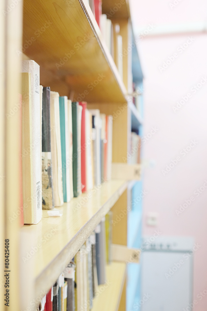 Books in a row. Bookshelf in public library. Books in a row. Bookshelf in public library.