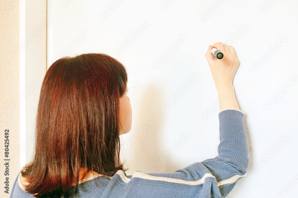 Fototapeta premium Student women writes on the board at the seminar