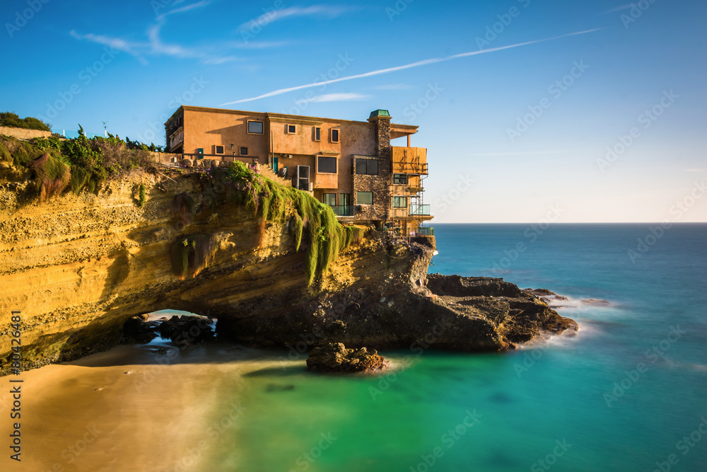 Long exposure of a house on a cliff and a small cove at Table Ro