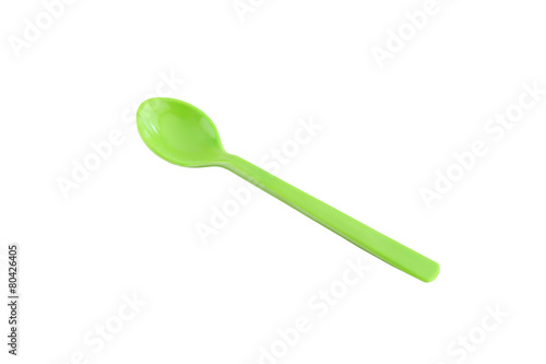 Green plastic spoon isolated on white.