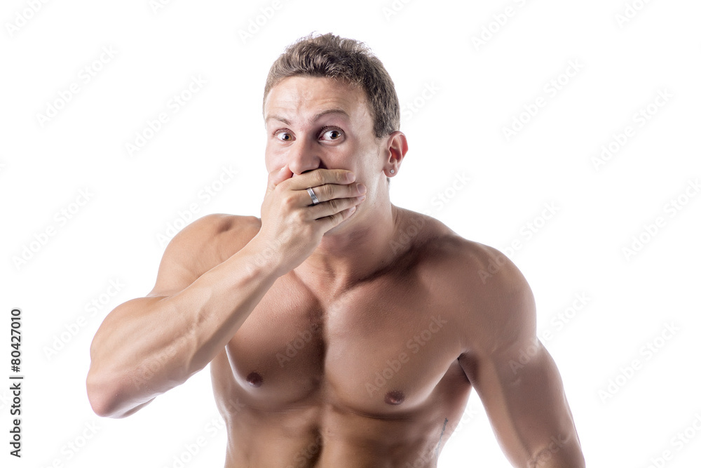 Naklejka premium Young man covering mouth with hand, not laughing