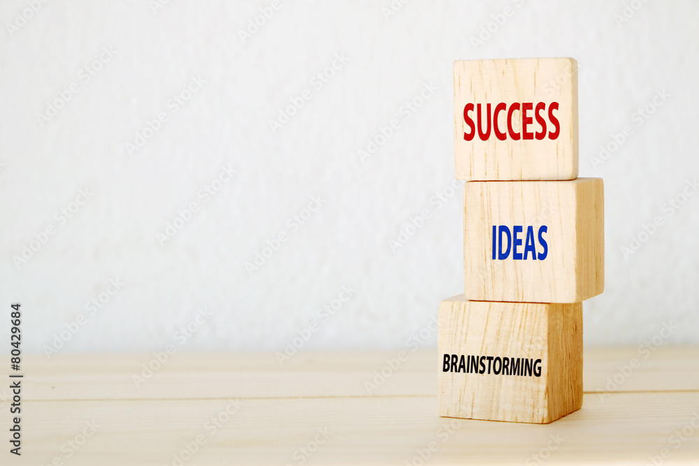 Brainstorming, ideas and success words on three wooden cubes Brainstorming, ideas and success words on three wooden cubes