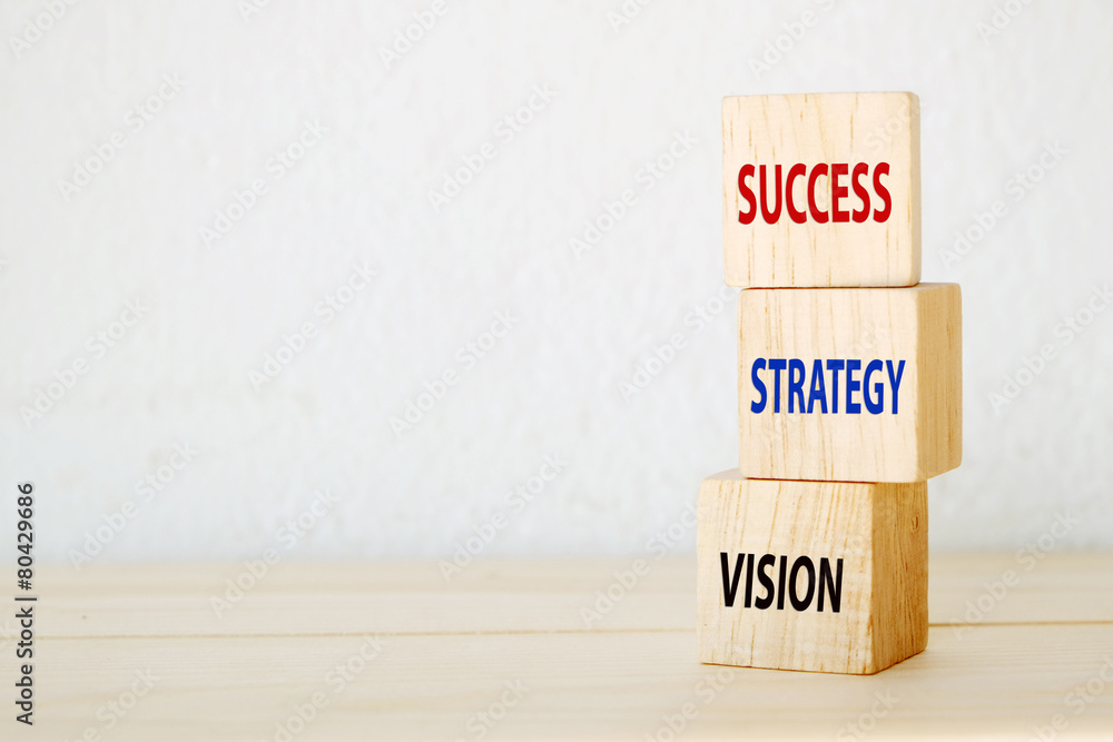 Vision, strategy and success words on three wooden cubes Vision, strategy and success words on three wooden cubes