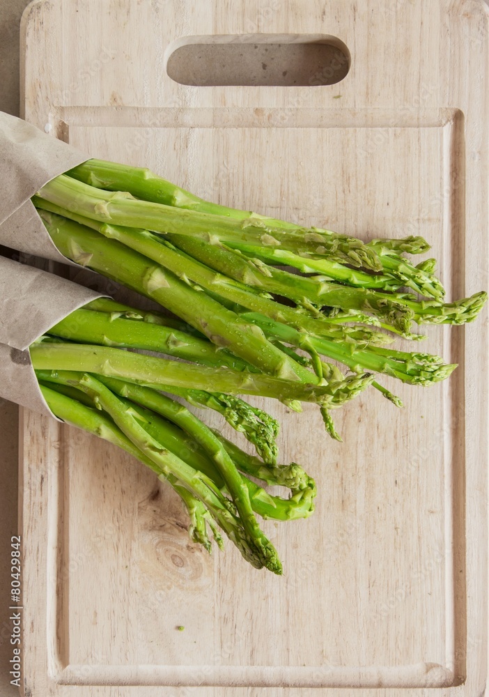Bunch of fresh asparagus on woodenBlock Bunch of fresh asparagus on woodenBlock