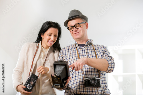 Man and woman hold retro camera
