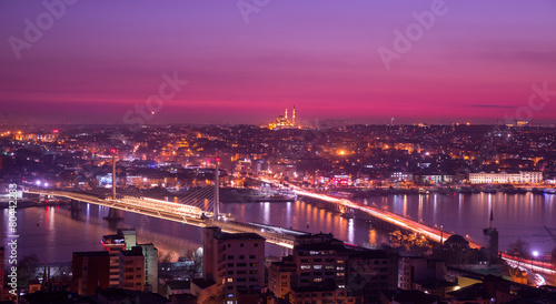 Golden horn at night with mosque skyline in pink