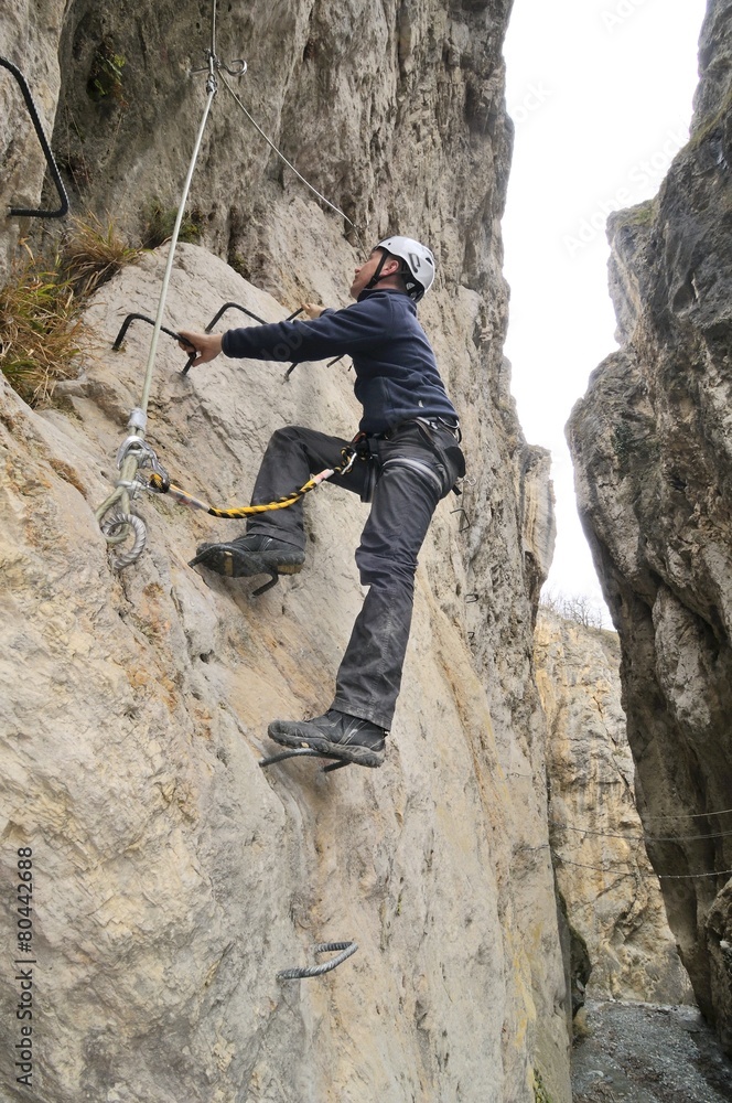 A hiker on the via ferrata of Chianocco ( Italy ) A hiker on the via ferrata of Chianocco ( Italy )