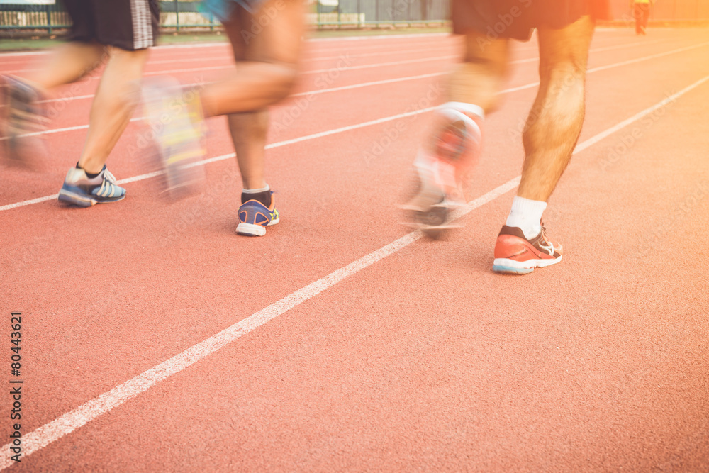 Running track with blur of runner feet in stadium Running track with blur of runner feet in stadium