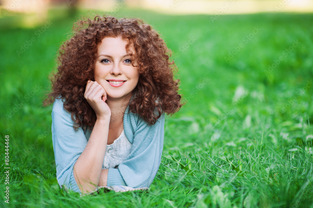 Summer girl portrait, smiling girl in green grass Summer girl portrait, smiling girl in green grass