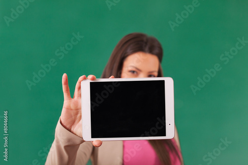 Beautiful woman showing a tablet