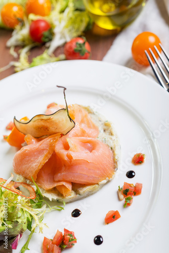 Creative composition delicious fresh smoked sliced salmon with