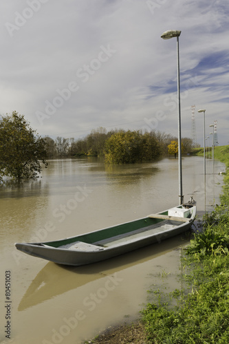 The Po is in flood A boat is secured to a lamppost