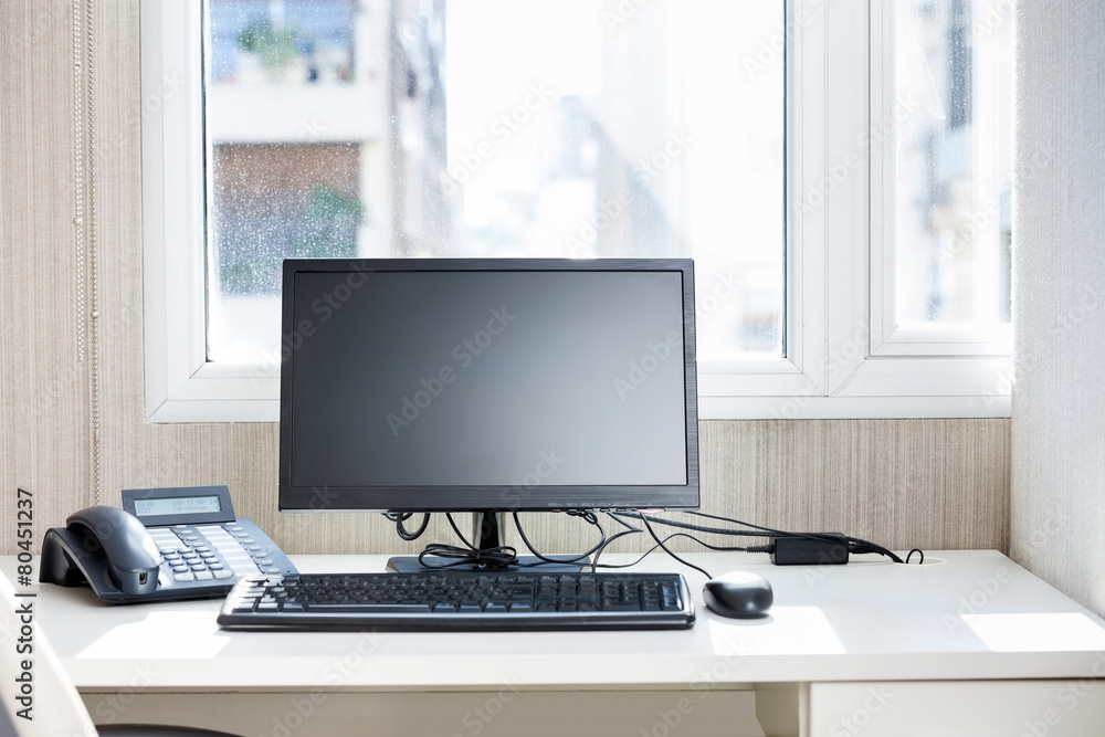 Computer And Landline Phone On Desk Computer And Landline Phone On Desk