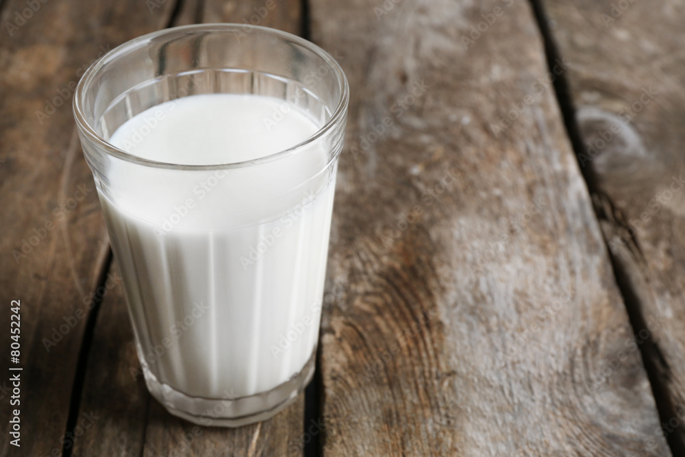 Glass of milk on rustic wooden planks background Glass of milk on rustic wooden planks background