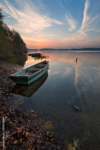 Fototapeta Naklejka Na Ścianę i Meble -  Sunset lake with fisherman boat landscape.