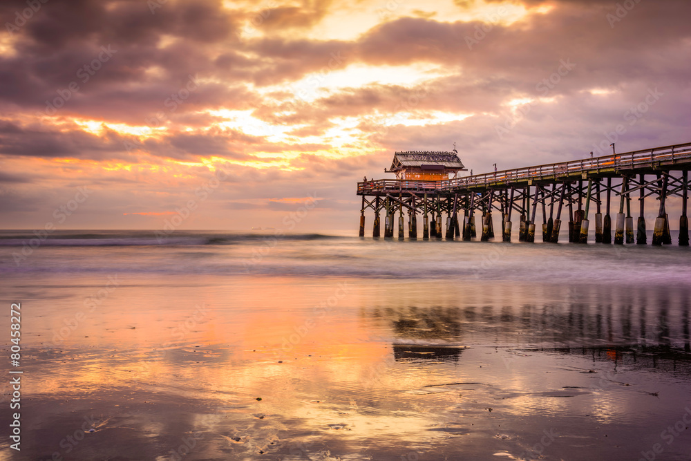 Cocoa Beach, Florida, USA beach and pier at sunrise.