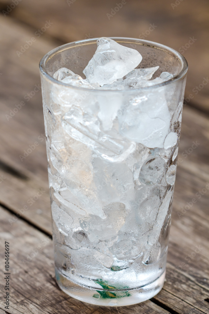 A glass of ice cubes on wooden A glass of ice cubes on wooden