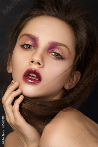 Beauty portrait of young brunette woman with modern salon makeup