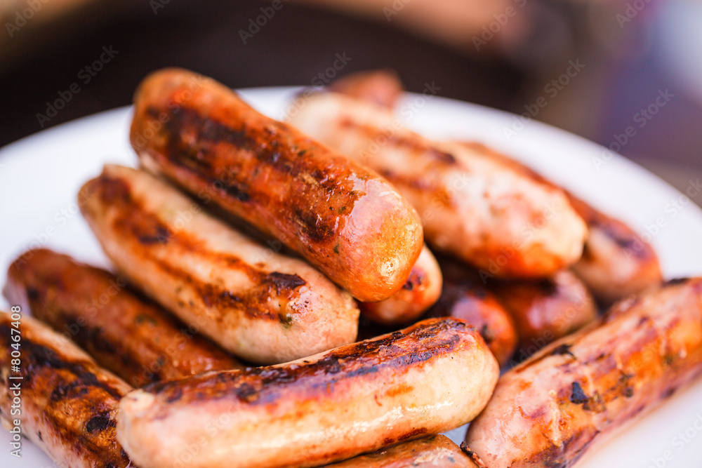 Barbecued beef and pork sausages on white plate Barbecued beef and pork sausages on white plate