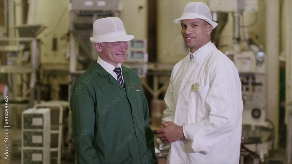 Portrait of friendly smiling factory workers in the food and drink industry