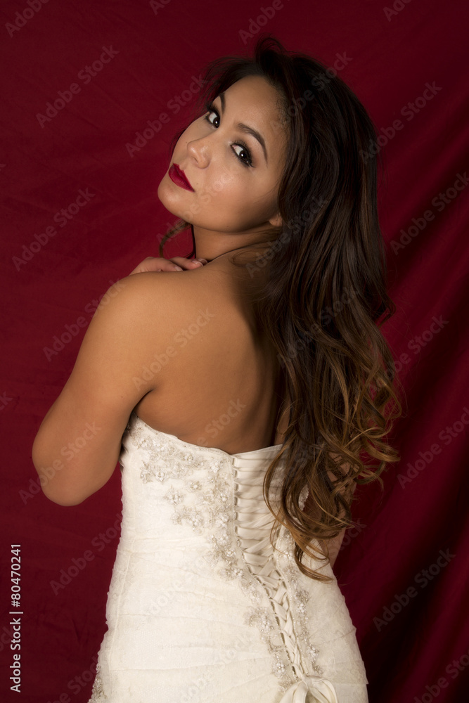 Fototapeta premium woman in wedding dress back look on red
